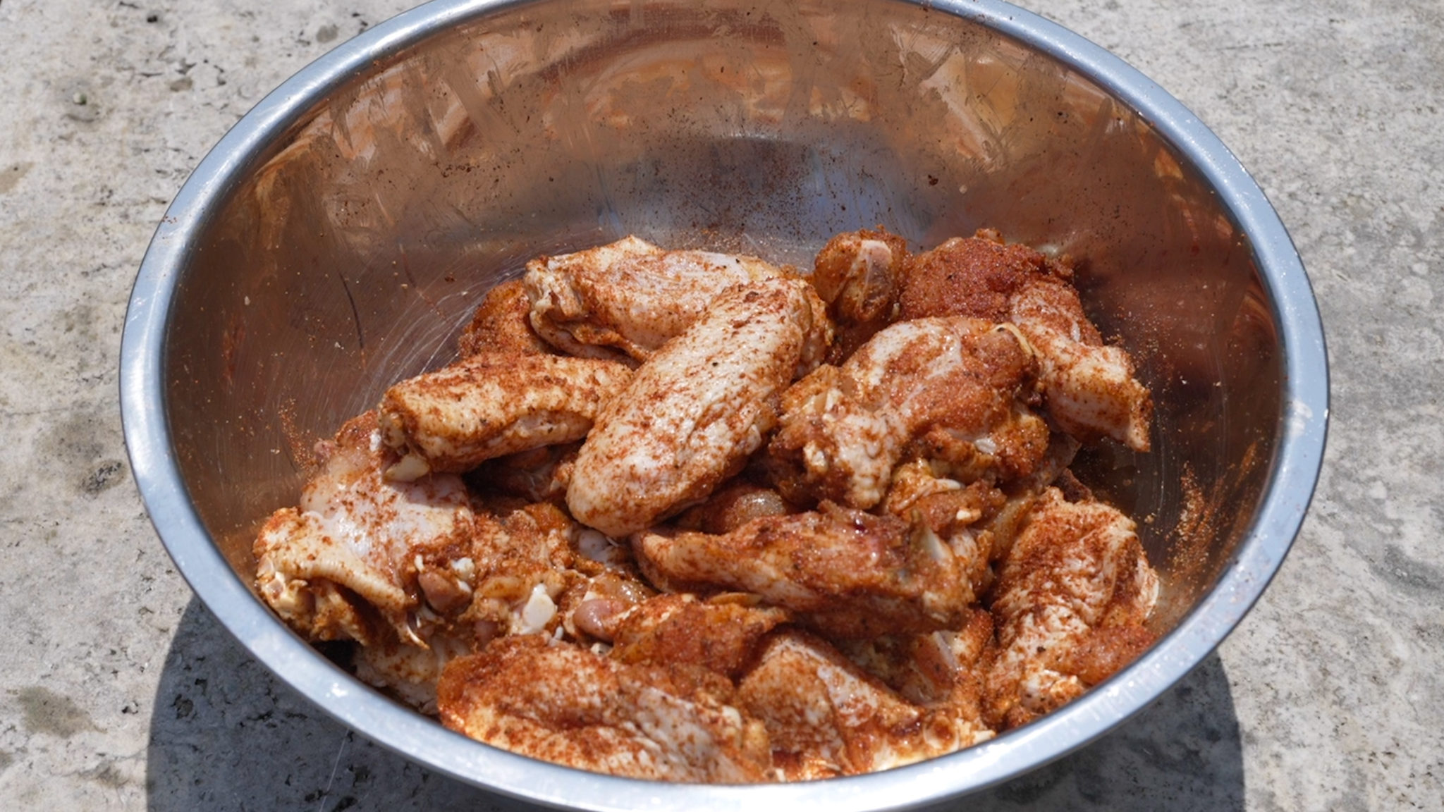 Wings sprinkled with dry rub for smoked hot wings