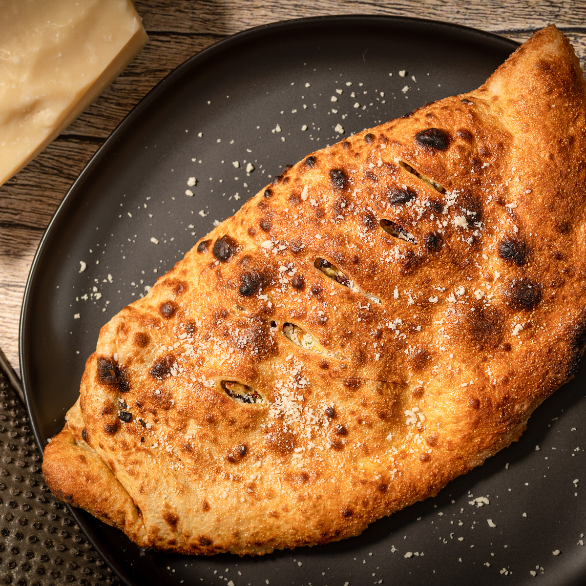 Whole chicken calzone on a plate.