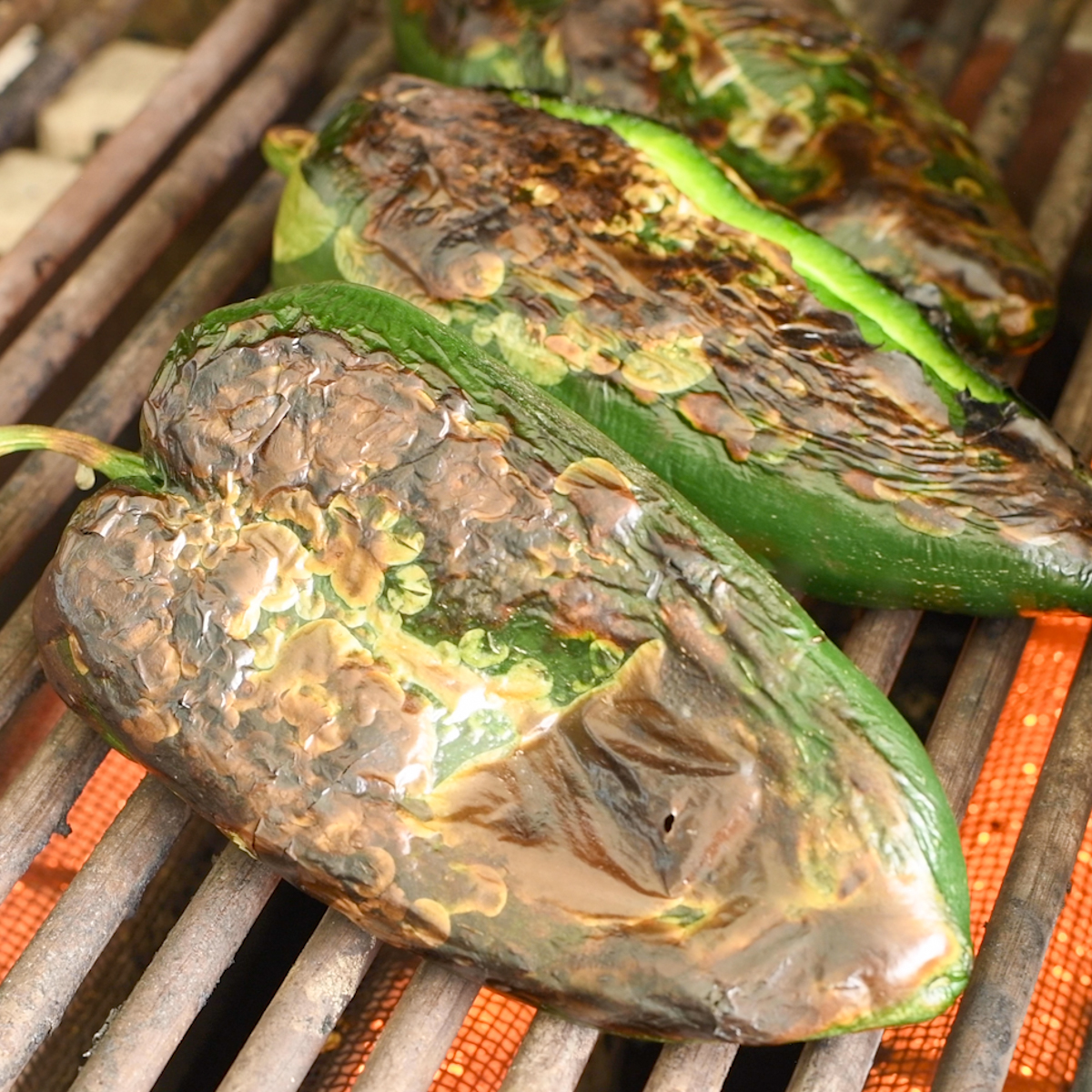 Roast poblano peppers on the barbecue.