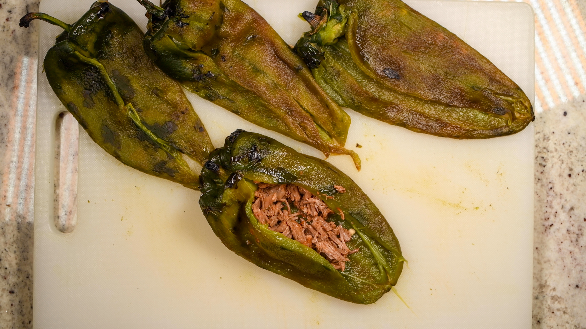 Place a heaping tablespoon of brisket inside each pepper.