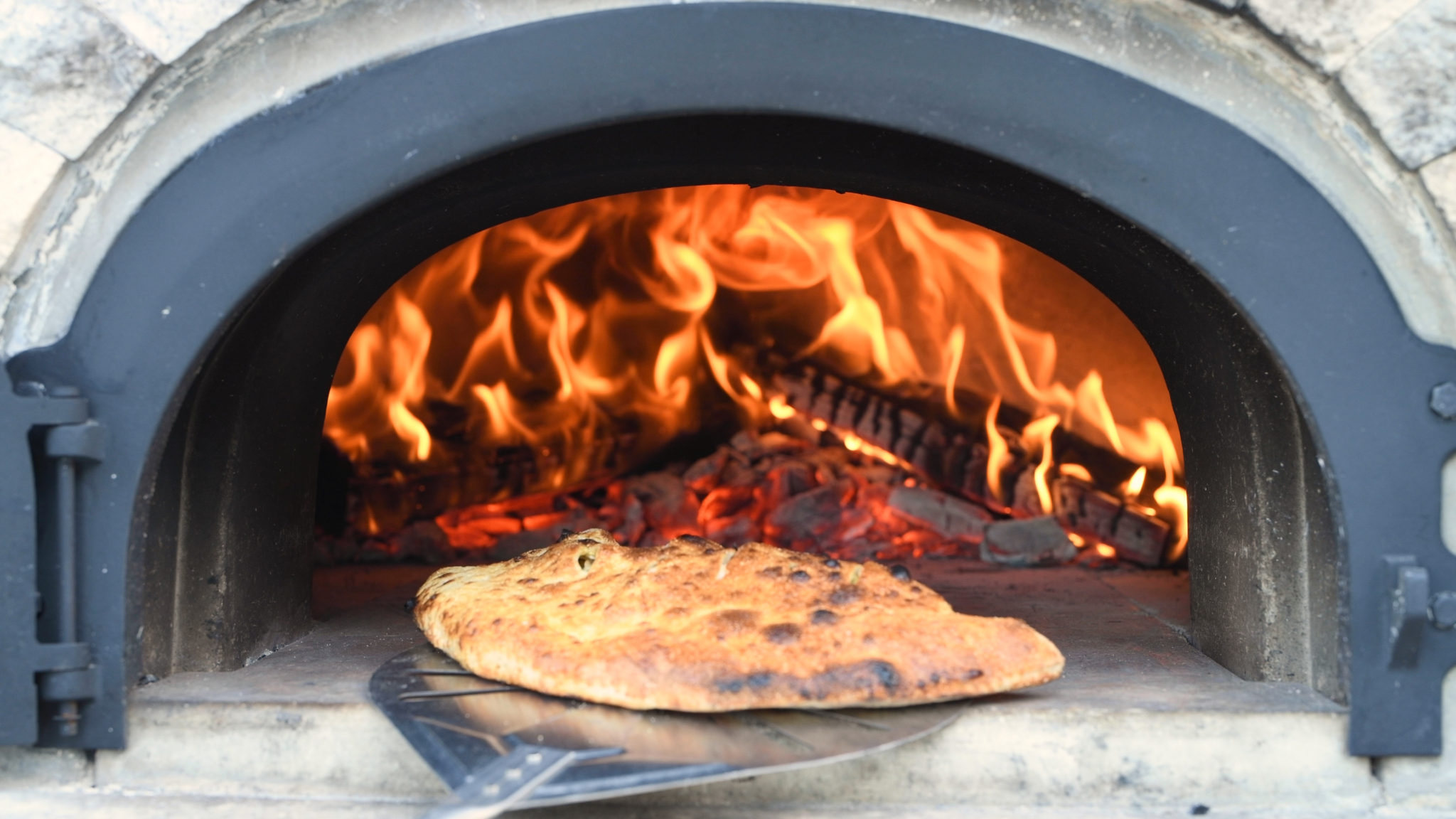 Calzone Coming Out of a Wood Fired Oven