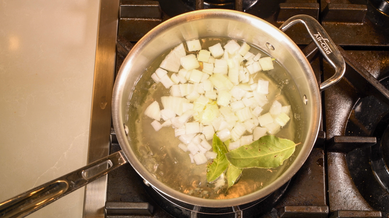 Boil the Chicken in Hot Water With Onions and Bay Leaves