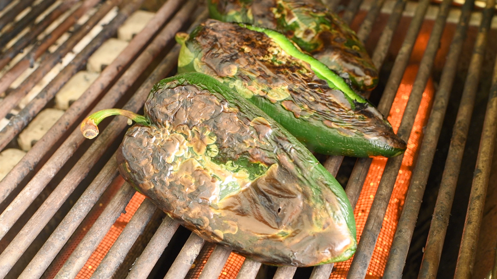 Roast the poblano peppers until slightly charred.