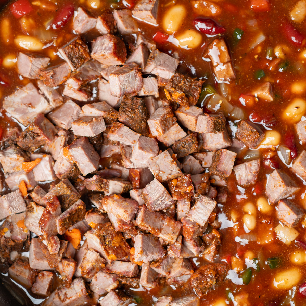 Add chopped brisket to the baked beans.