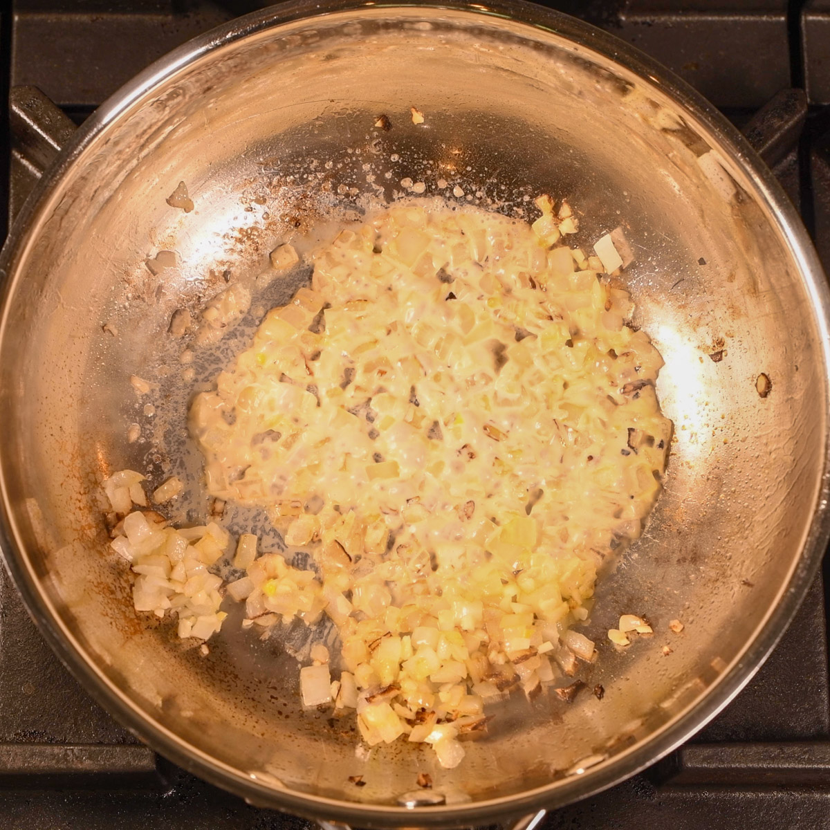 Add heavy cream to the onion and garlic.