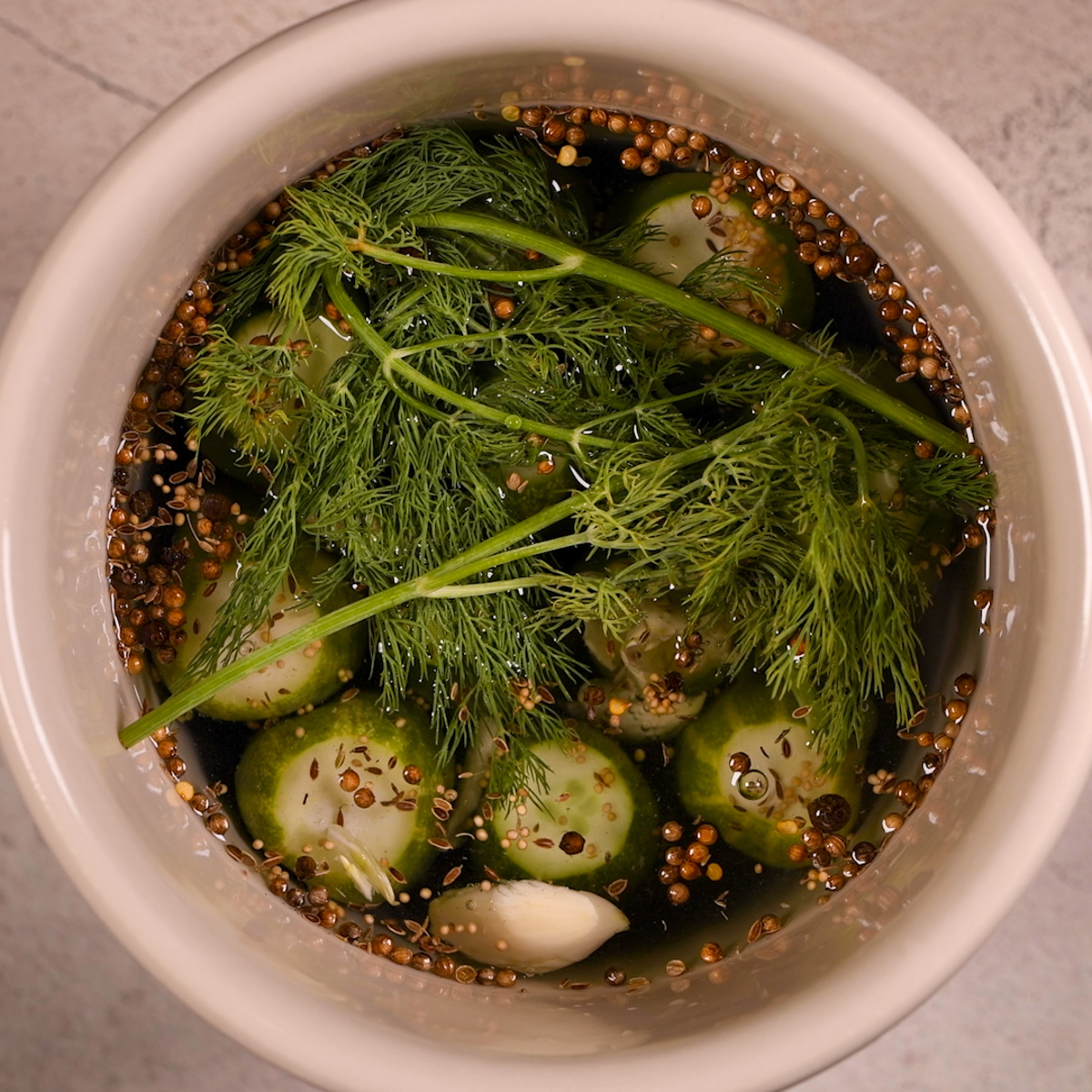 Add dill to the pickling crock.