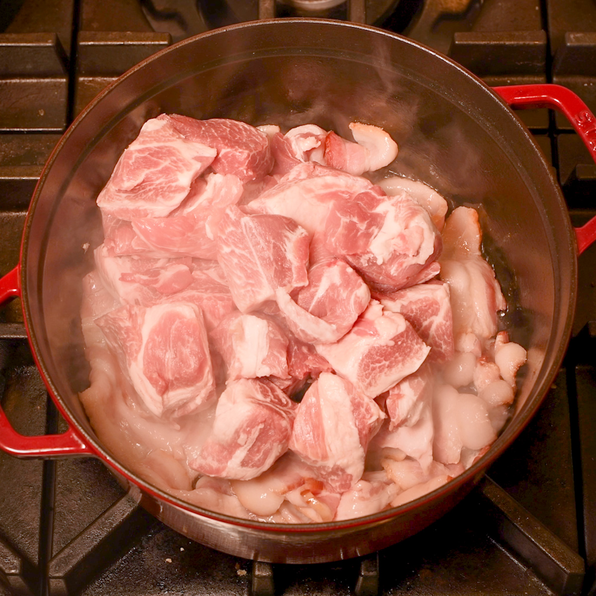 Add the pork shoulder pieces and sear all sides.