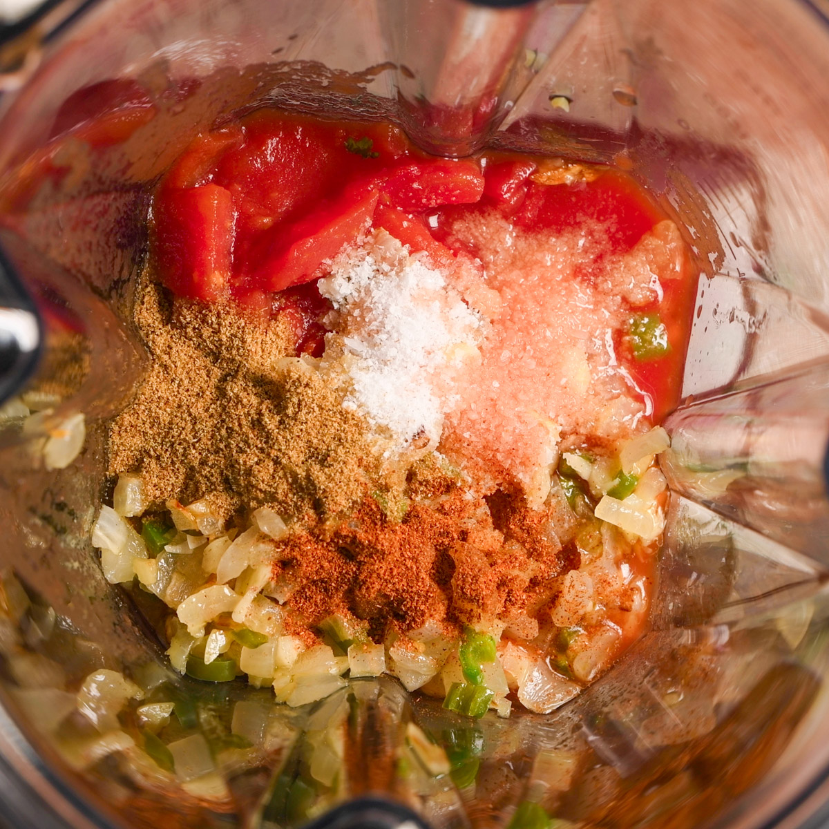 Add onion and spices to a blender.