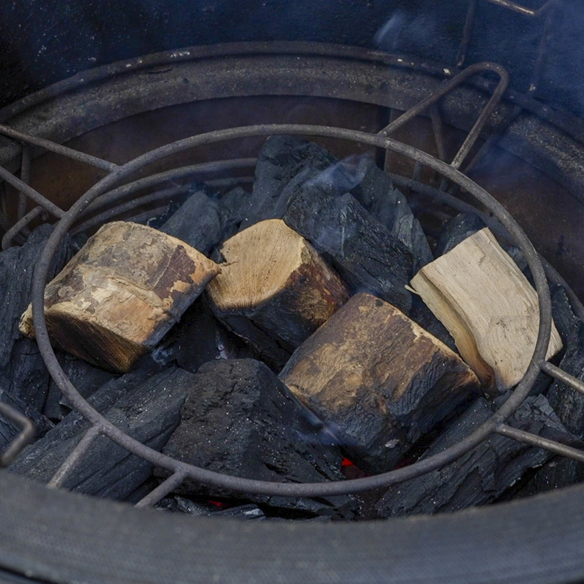 Add wood chunks on top of hot coals.