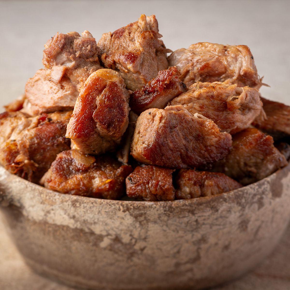 Bowl of seared carnitas meat.