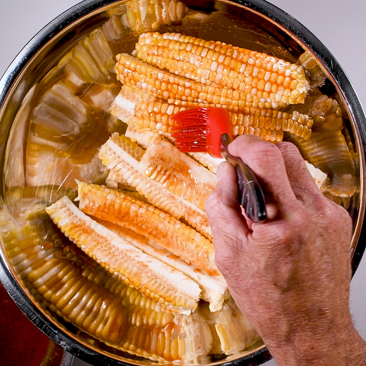 Brush the corn ribs with the marinade.