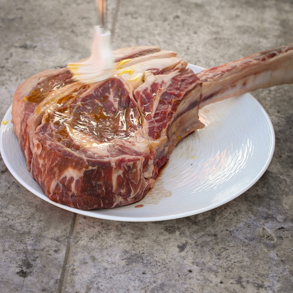 Brush the tomahawk steak with oil