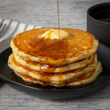 Buttermilk pancakes with butter and syrup.