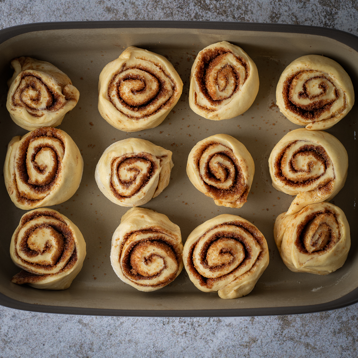 Cut cinnamon rolls in a prepared 9 X 13 pan .