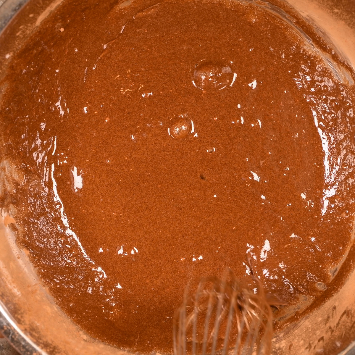 Eggs, sugar, vanilla and cocoa powder after stirring.