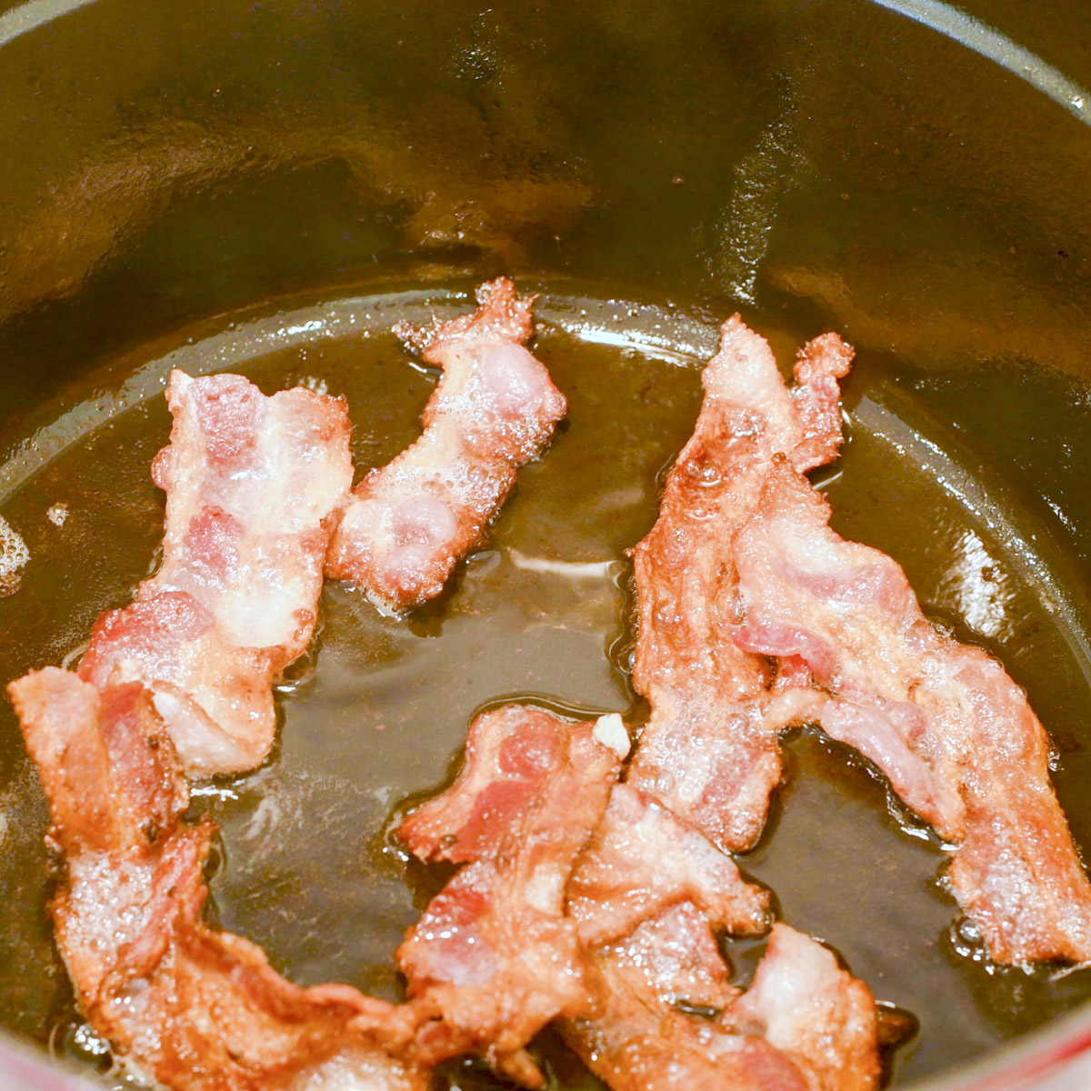 Cook bacon in a Dutch oven.