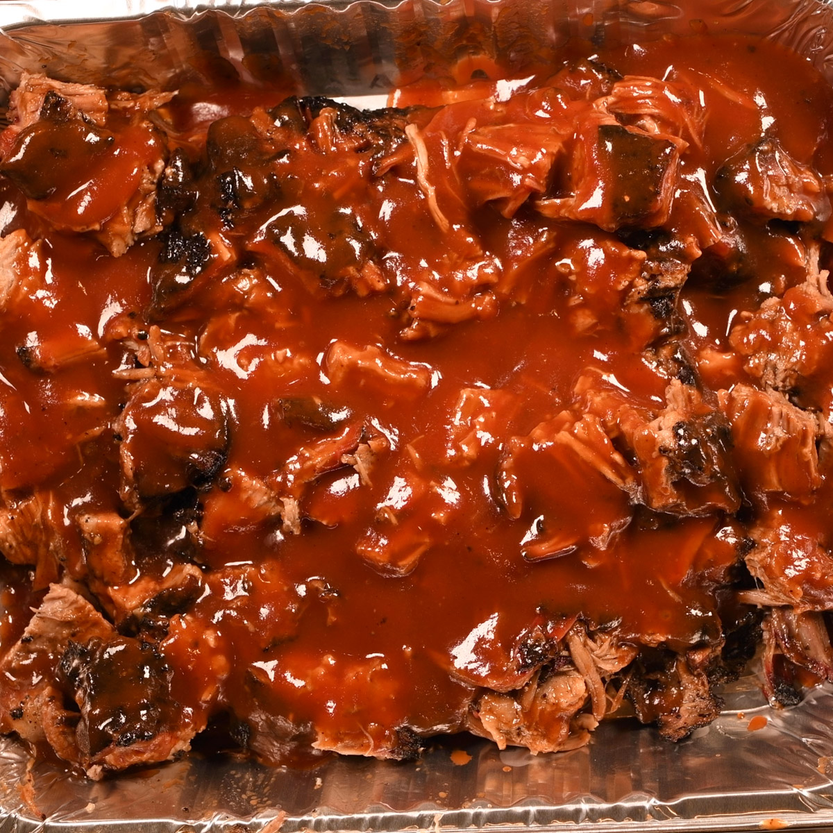 Burnt ends with BBQ sauce.