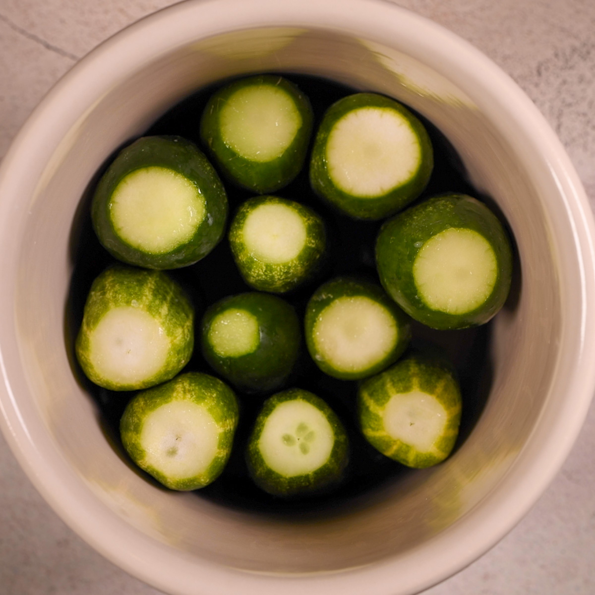 Place cucumbers in a pickling crock.