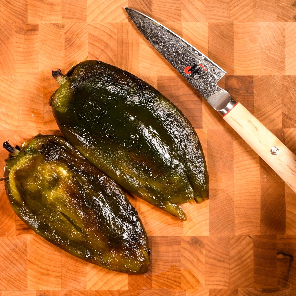 Cut a slit down the side of each poblano and remove the seeds.