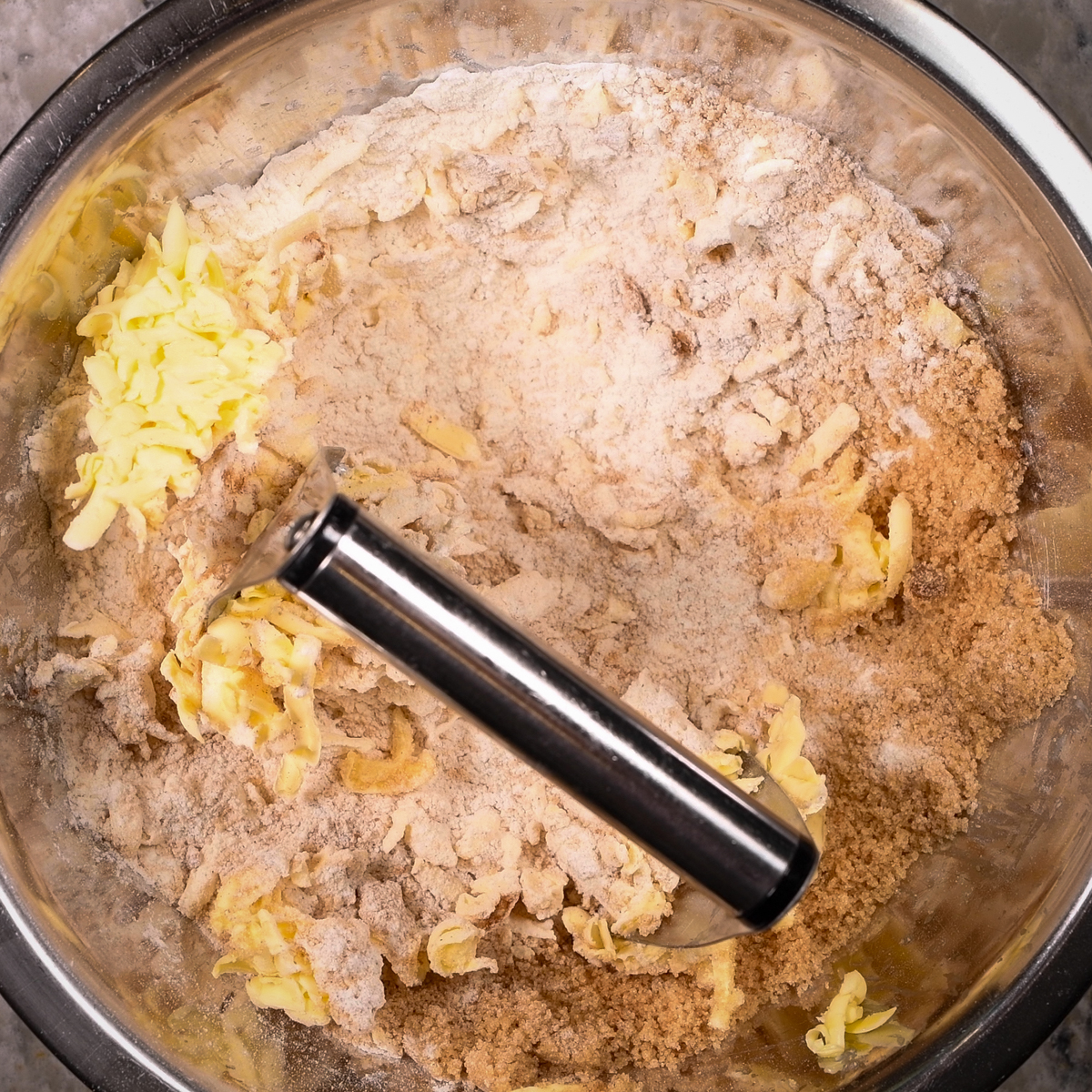 Cut the butter into the blueberry crisp topping.