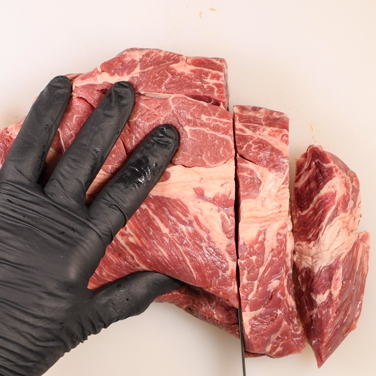 Cut the boneless pork shoulder into 1" pieces.