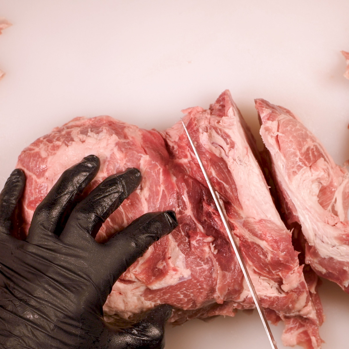 Cut pork shoulder into 2" pieces.