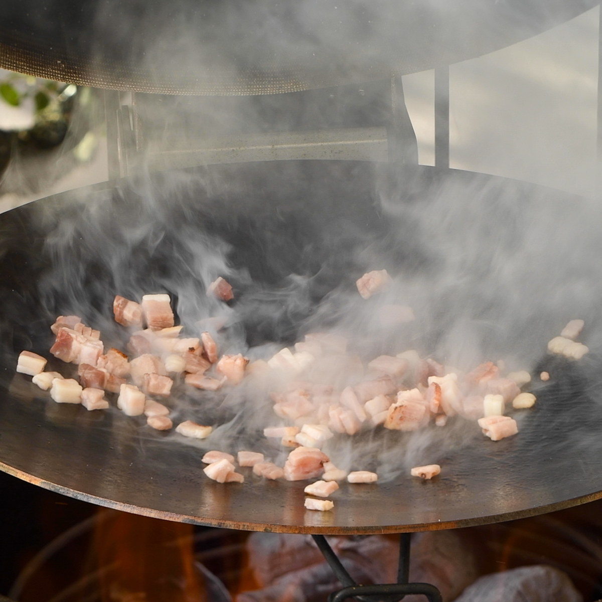 Bacon cooking on a discada