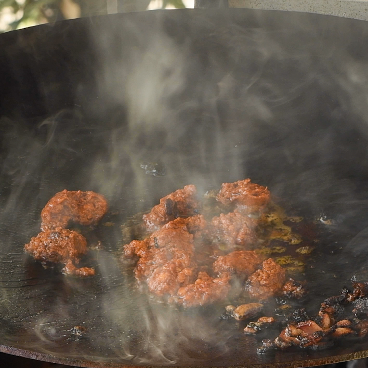 Chorizo cooking on a discada