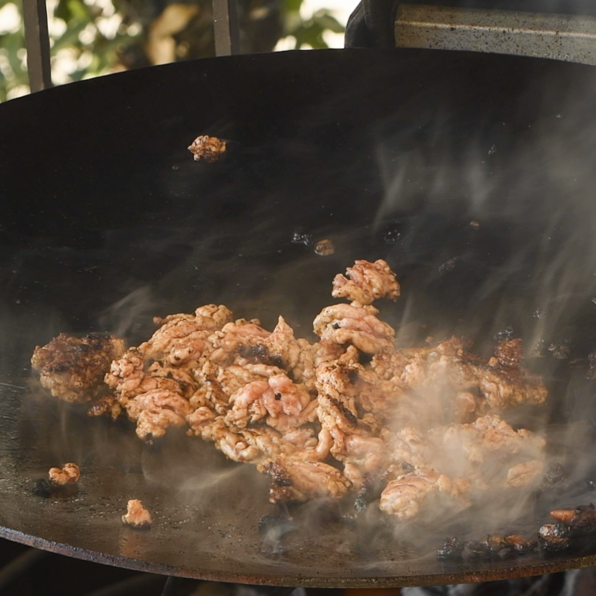 Ground pork cooking on a discada