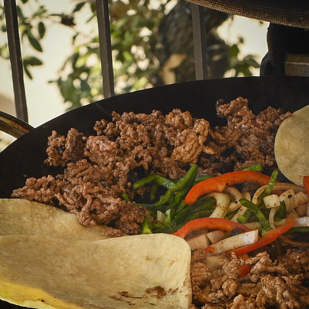 Flour tortillas cooking on a discada