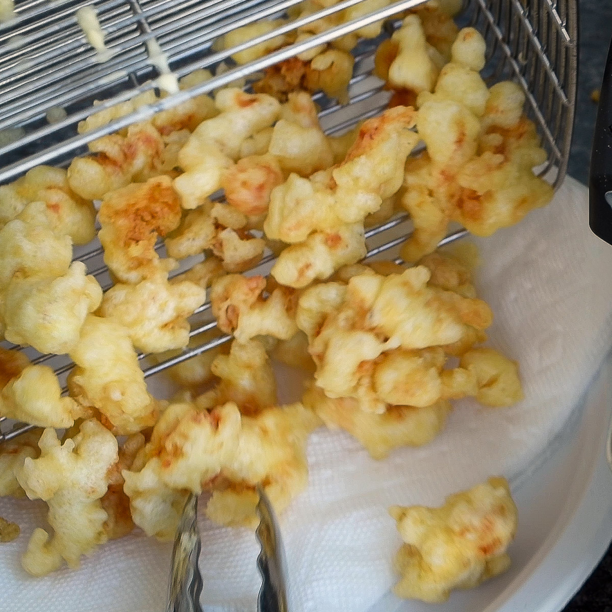 Drain hot crawfish tempura on paper towels for 30 seconds.