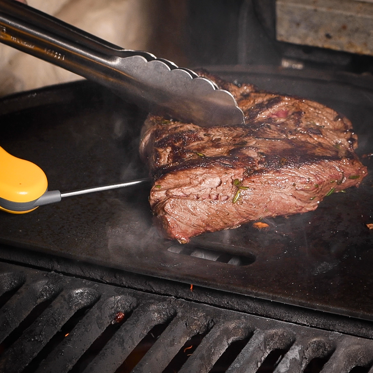 Checking the temperature of a flat iron steak.