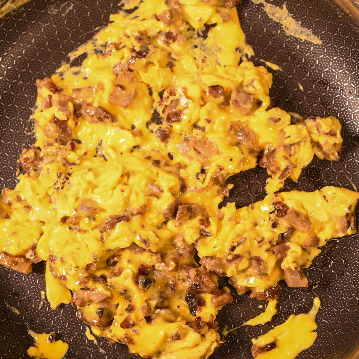 Fold eggs into chopped brisket and cook until eggs are set.