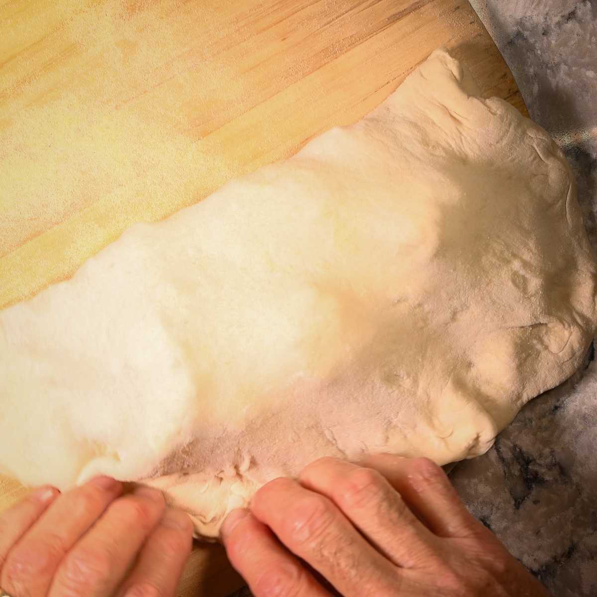 Fold over the calzone dough and press to seal.