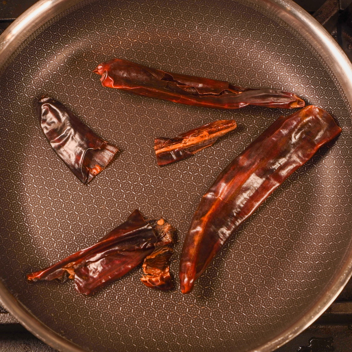 Toast dried chiles in a hot skillet over medium heat.