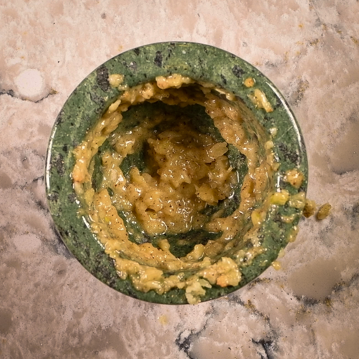 Mash the garlic with olive oil in a mortar and pestle.