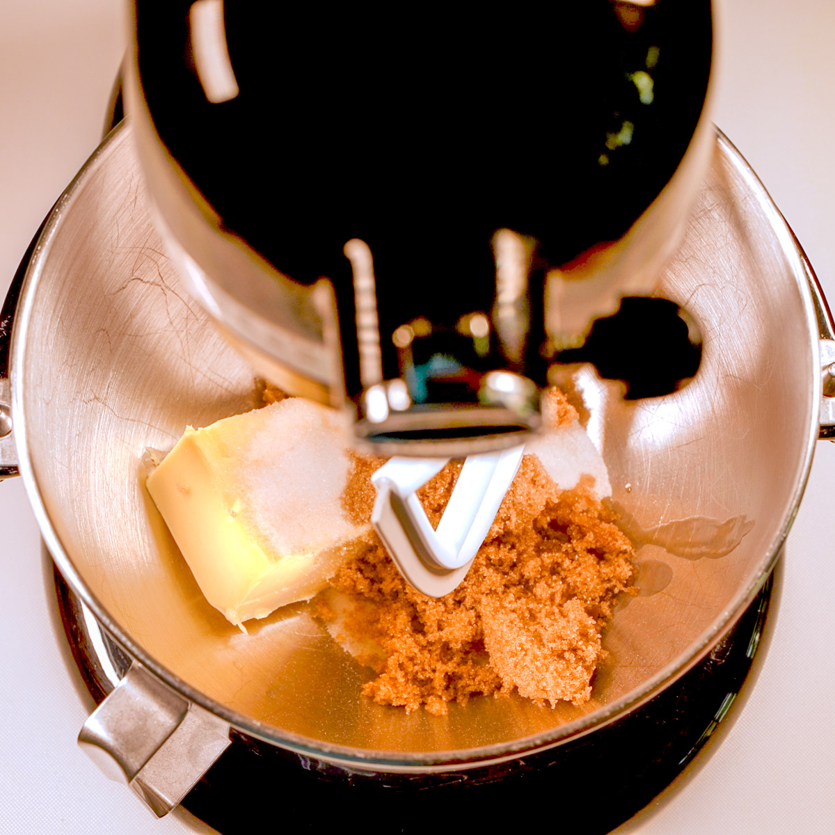 Mix the butter and brown sugar in a stand mixer.