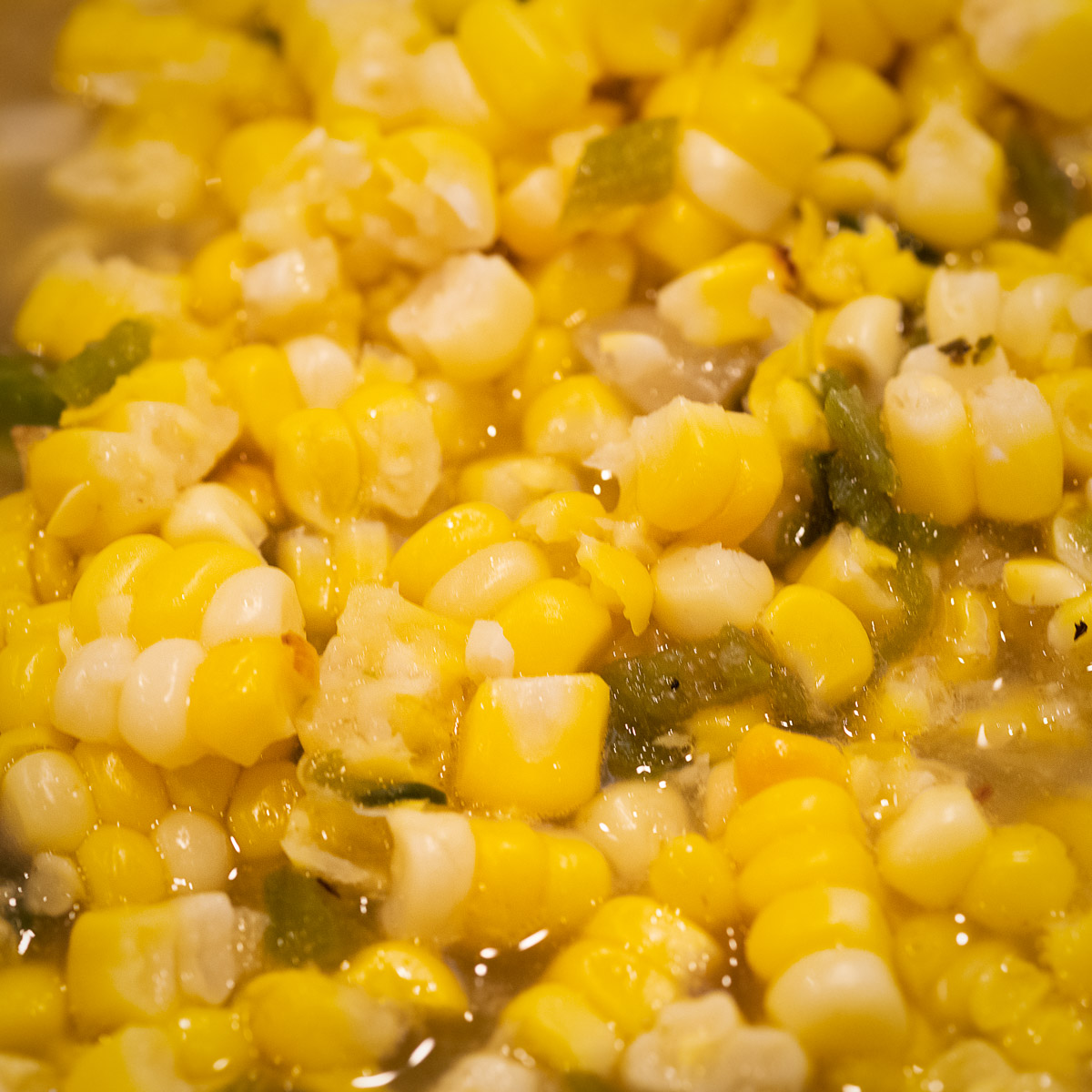 Corn mixed with poblano peppers.