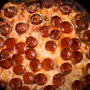 Finished pepperoni pan pizza ready to cut.