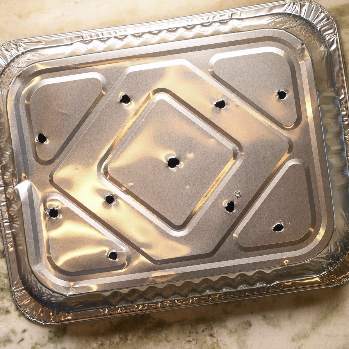 Punch holes in aluminum pan to let excess grease drain out.