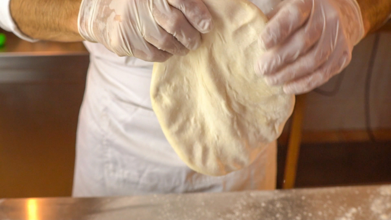 Hold the Dough Vertically and Gently Stretch the Rim