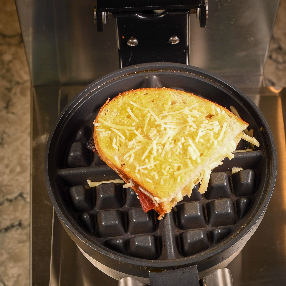 Place the sandwich in the middle of the waffle maker.