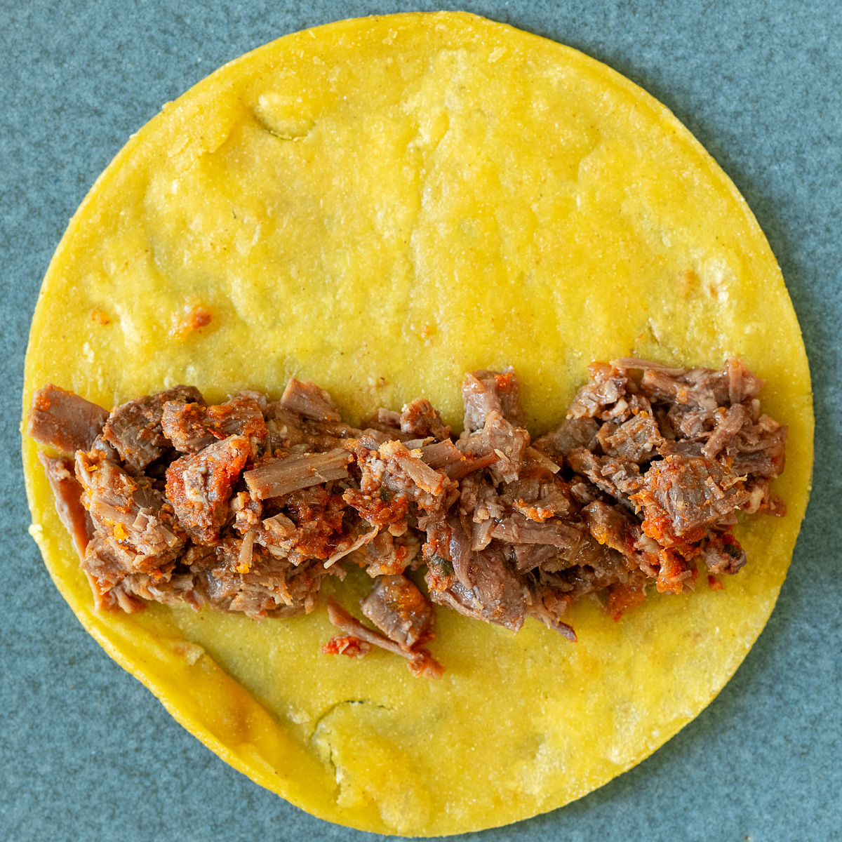 Place brisket in the bottom third of the tortilla.