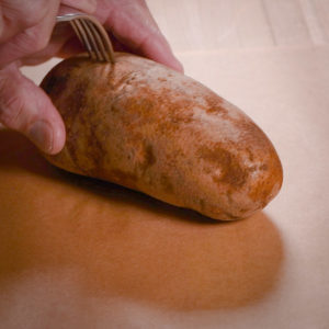 Poke holes in the potatoes.