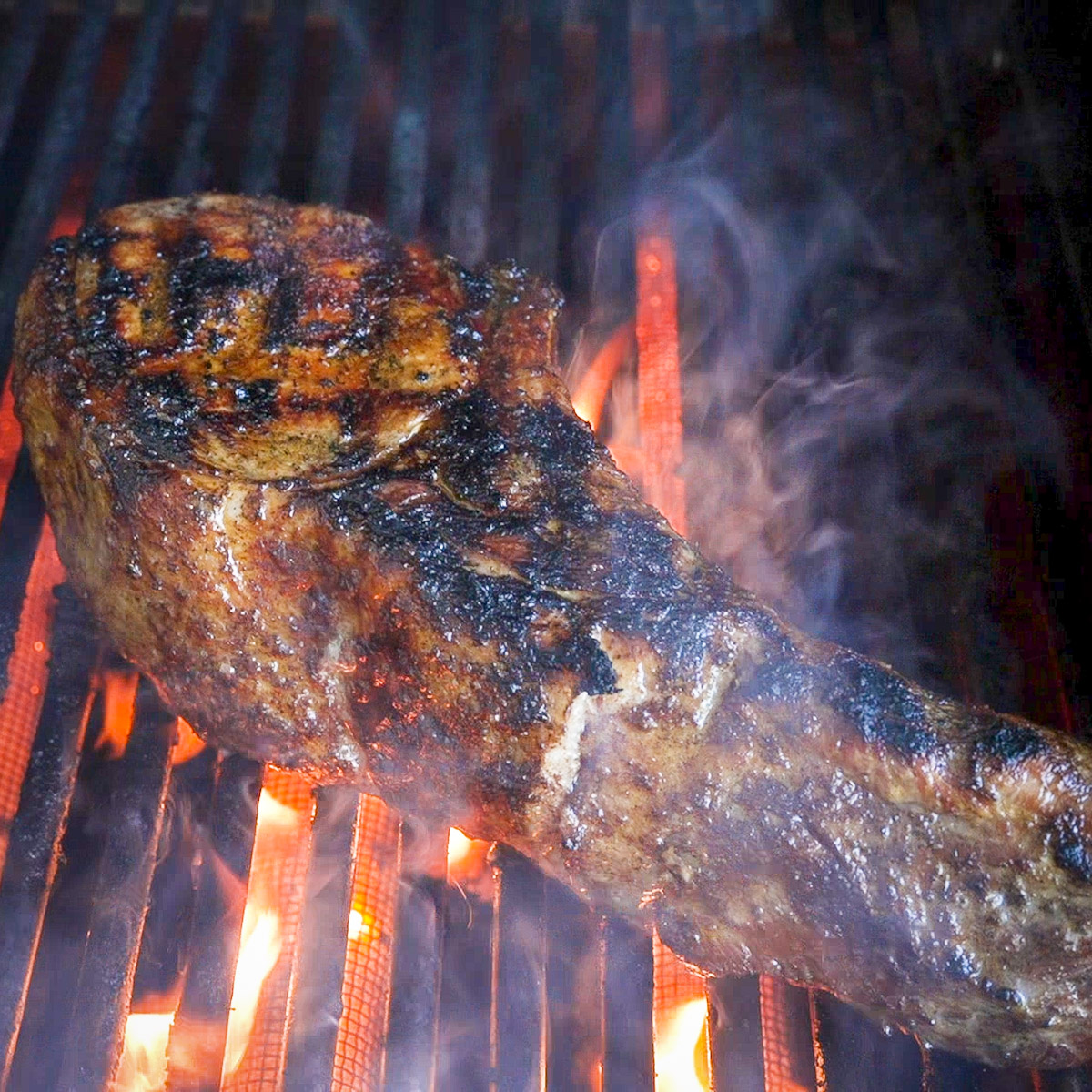 Sear the pork chops on a hot grill.