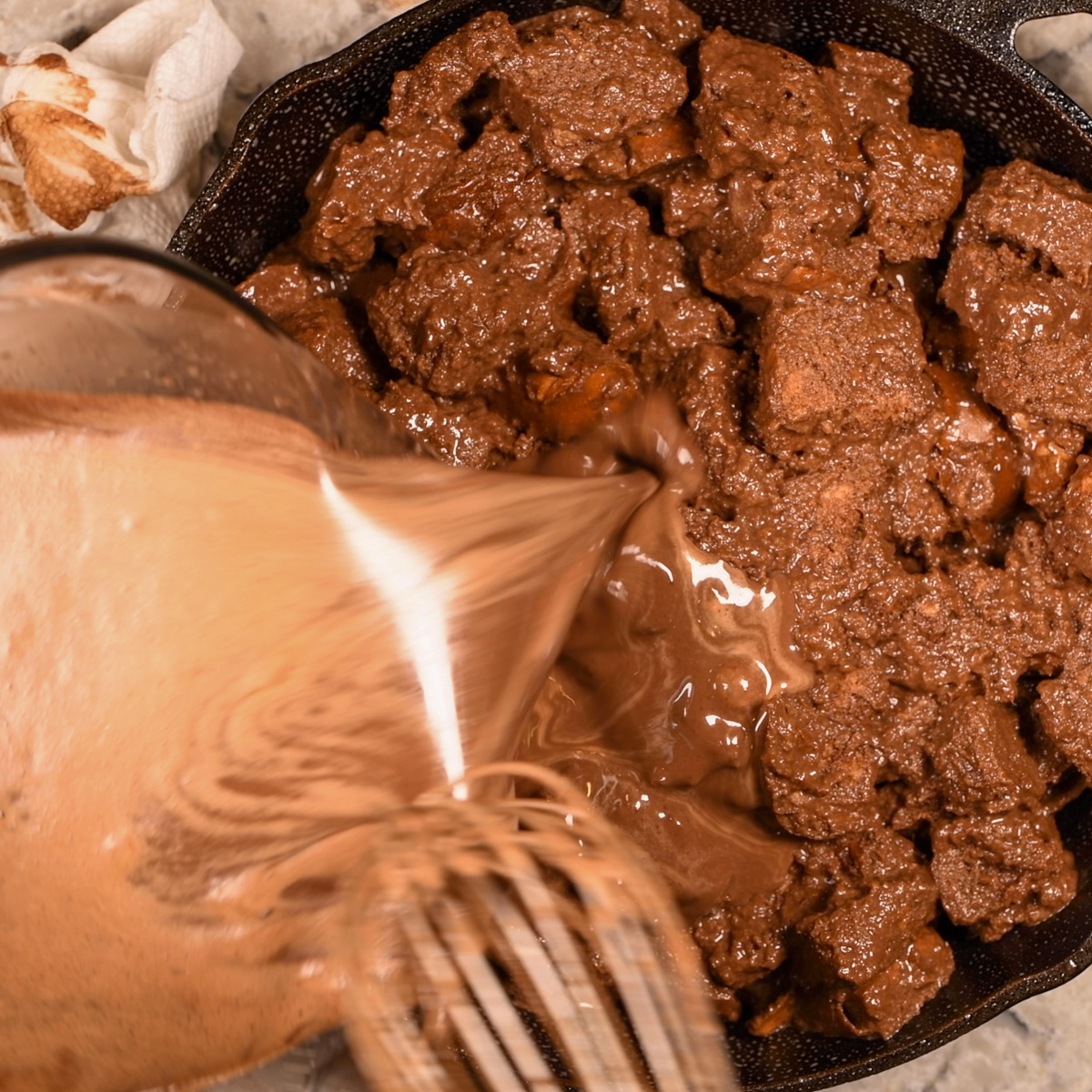 Pour remaining chocolate mixture over bread cubes.