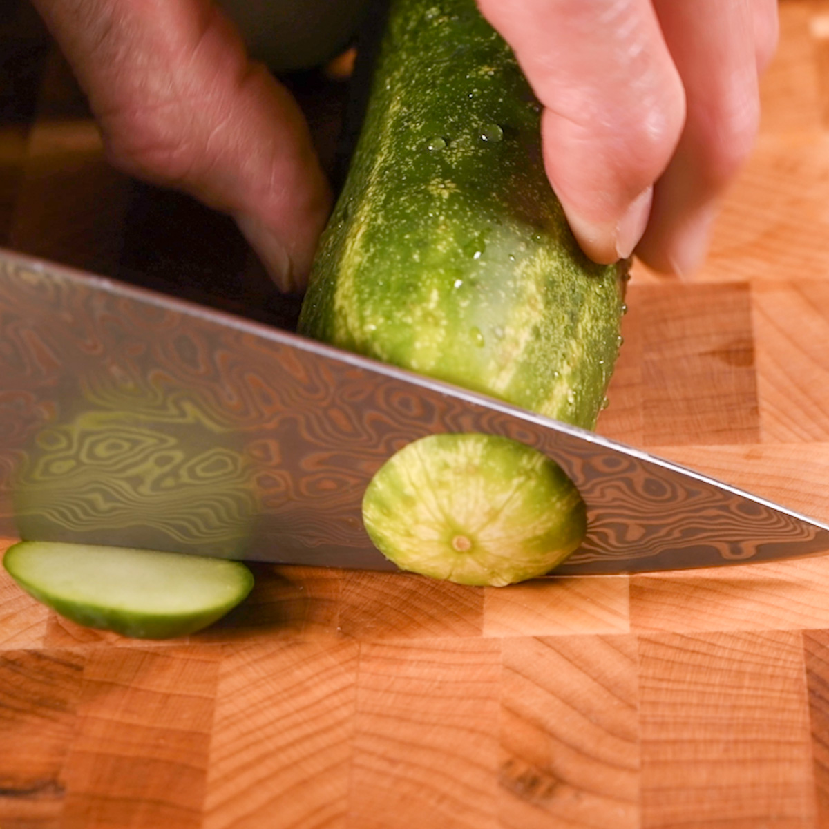 Trim off the ends of the cucumbers.