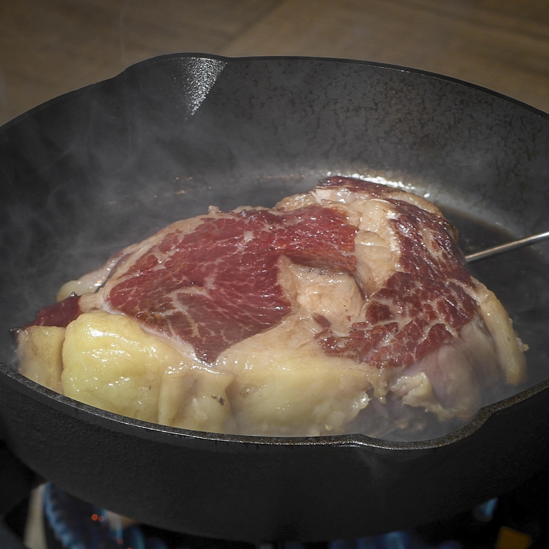 Ribeye with reverse sear in a cast-iron skillet.