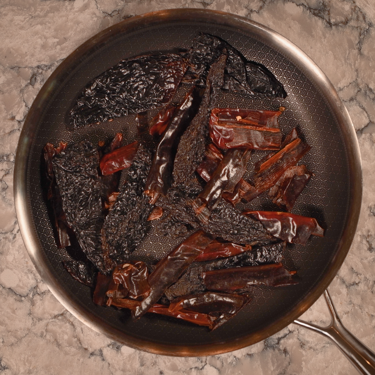 Roast the dried chiles in a hot skillet.