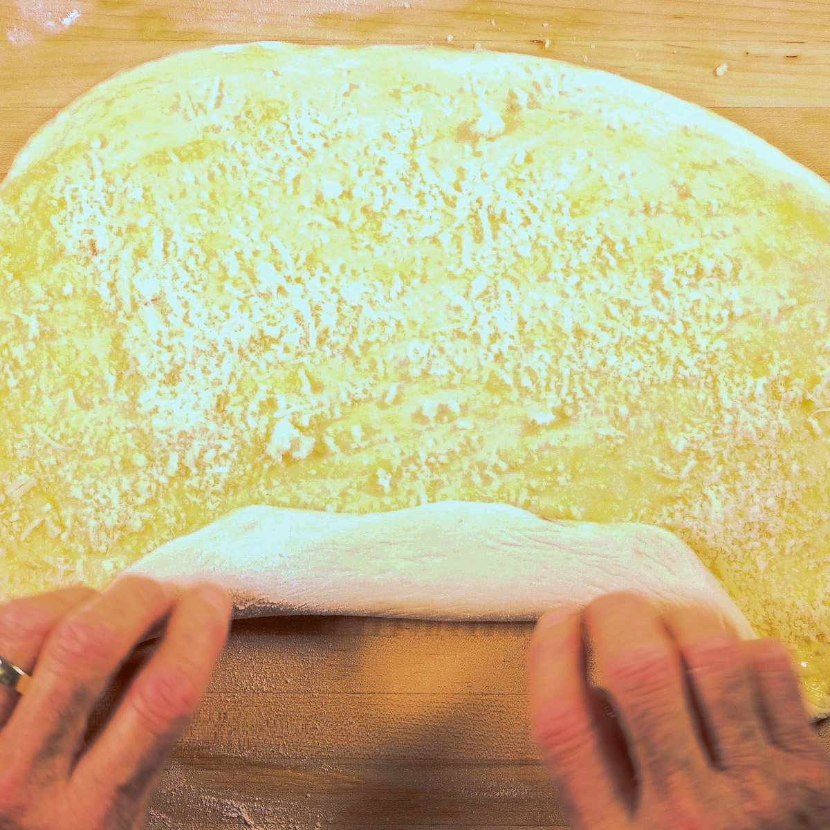Roll up the dough with cheese and garlic inside.